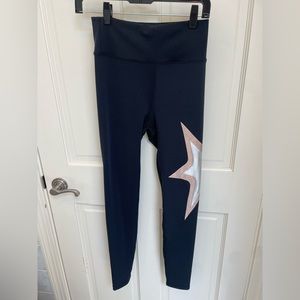 Heroine Sport adorable black leggings with a sparkly metallic star embroidery